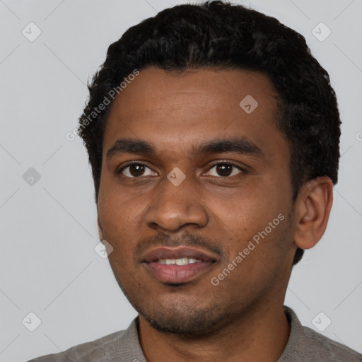 Joyful black young-adult male with short  black hair and brown eyes