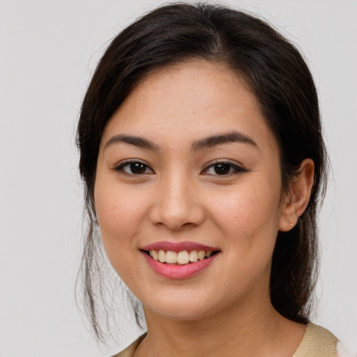 Joyful asian young-adult female with medium  brown hair and brown eyes