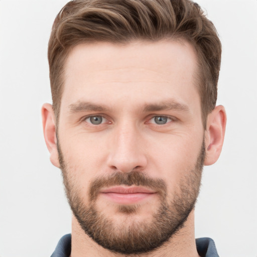 Joyful white young-adult male with short  brown hair and grey eyes