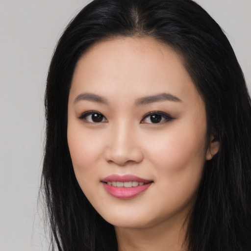 Joyful asian young-adult female with long  black hair and brown eyes
