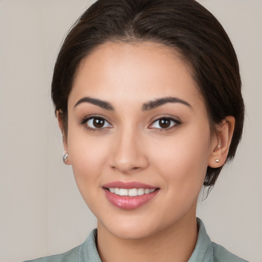 Joyful white young-adult female with medium  brown hair and brown eyes