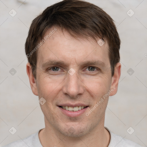 Joyful white adult male with short  brown hair and grey eyes