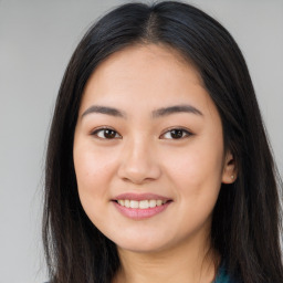 Joyful asian young-adult female with long  brown hair and brown eyes