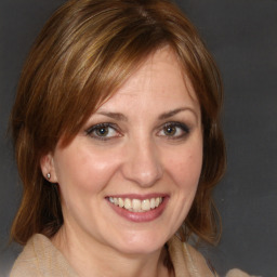 Joyful white adult female with medium  brown hair and brown eyes