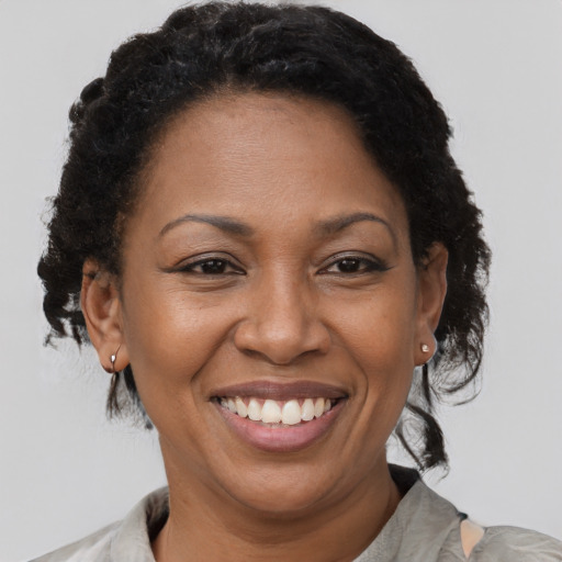 Joyful black adult female with short  brown hair and brown eyes