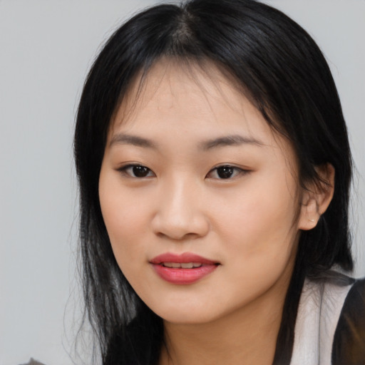 Joyful asian young-adult female with long  black hair and brown eyes