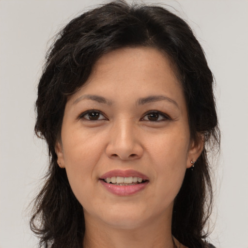 Joyful white adult female with long  brown hair and brown eyes