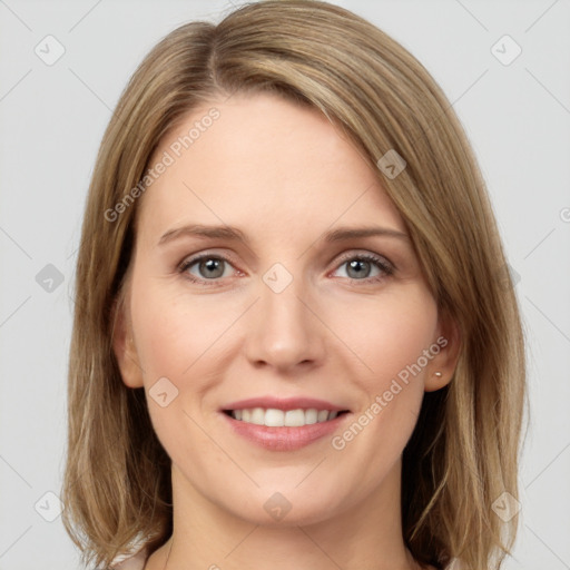 Joyful white young-adult female with long  brown hair and grey eyes