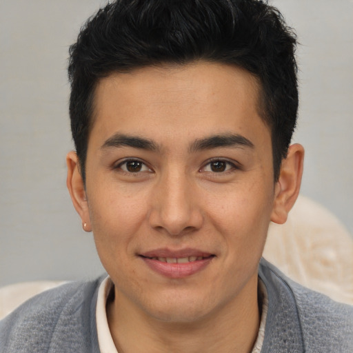 Joyful latino young-adult male with short  brown hair and brown eyes