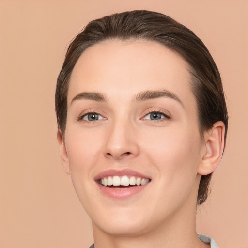 Joyful white young-adult female with medium  brown hair and brown eyes