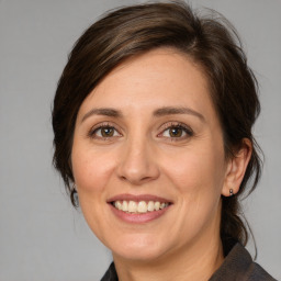 Joyful white adult female with medium  brown hair and brown eyes