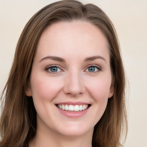 Joyful white young-adult female with long  brown hair and grey eyes