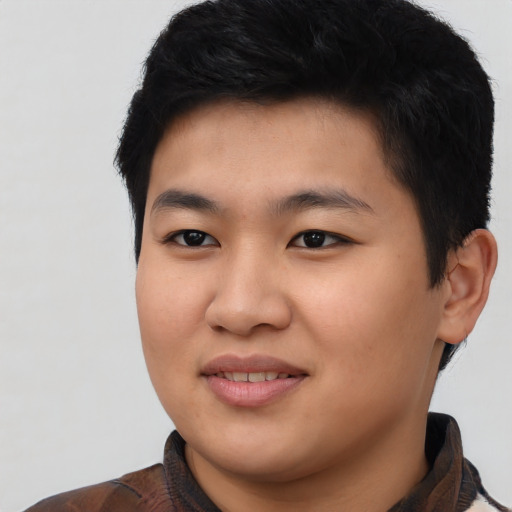 Joyful asian young-adult male with short  black hair and brown eyes