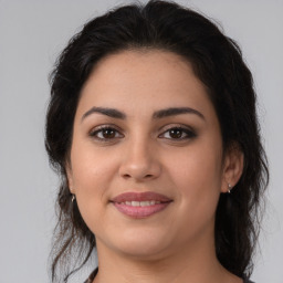 Joyful latino young-adult female with medium  brown hair and brown eyes