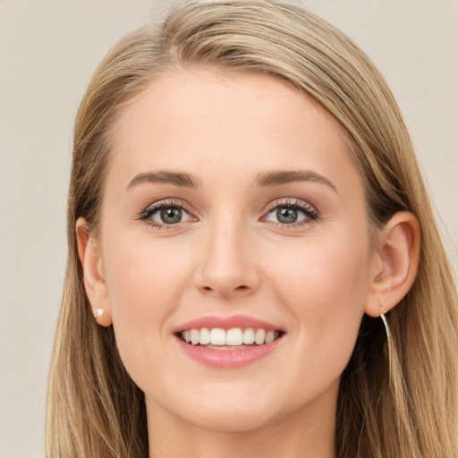 Joyful white young-adult female with long  brown hair and blue eyes