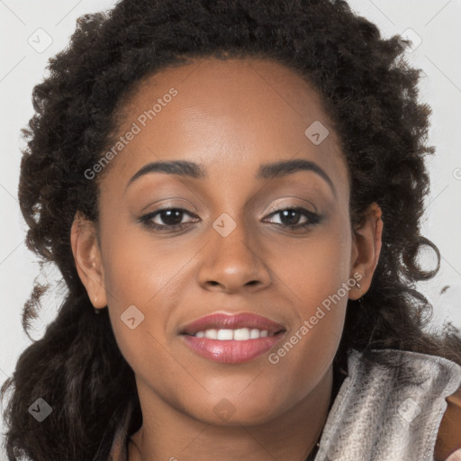 Joyful black young-adult female with long  brown hair and brown eyes