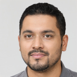 Neutral latino young-adult male with short  black hair and brown eyes
