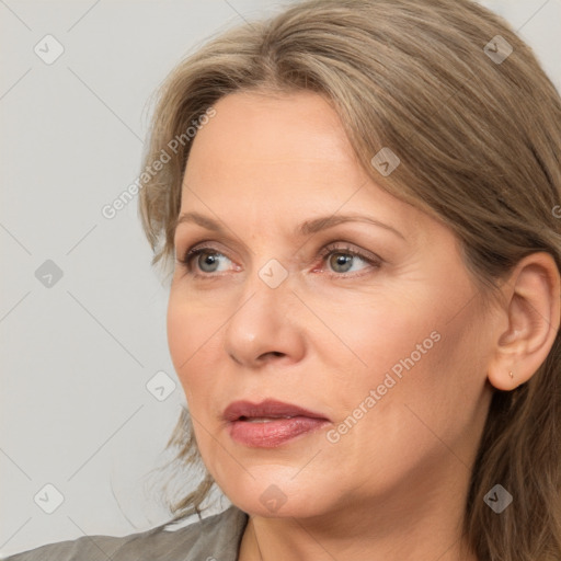 Joyful white adult female with medium  brown hair and grey eyes