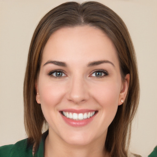 Joyful white young-adult female with long  brown hair and green eyes