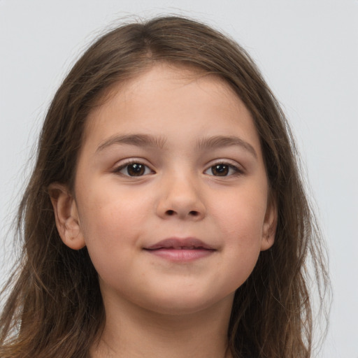 Joyful white child female with long  brown hair and brown eyes