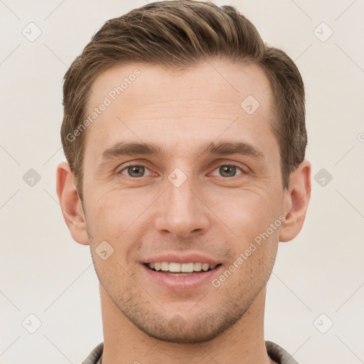 Joyful white young-adult male with short  brown hair and grey eyes