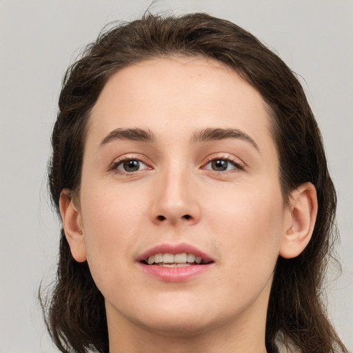 Joyful white young-adult female with medium  brown hair and brown eyes