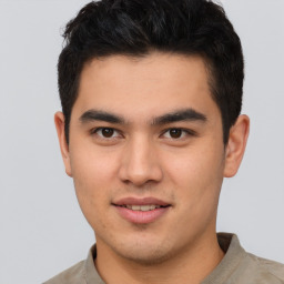 Joyful latino young-adult male with short  brown hair and brown eyes