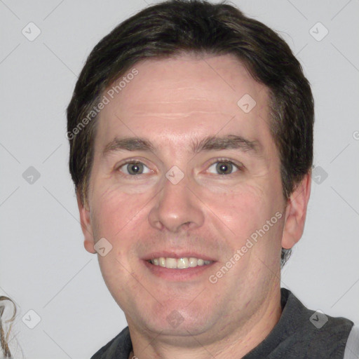 Joyful white adult male with short  brown hair and grey eyes