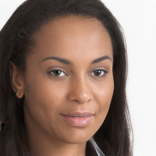 Joyful black young-adult female with long  brown hair and brown eyes