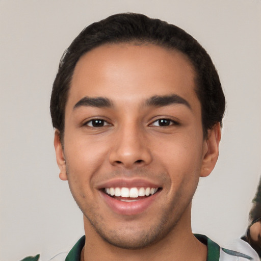 Joyful white young-adult male with short  black hair and brown eyes