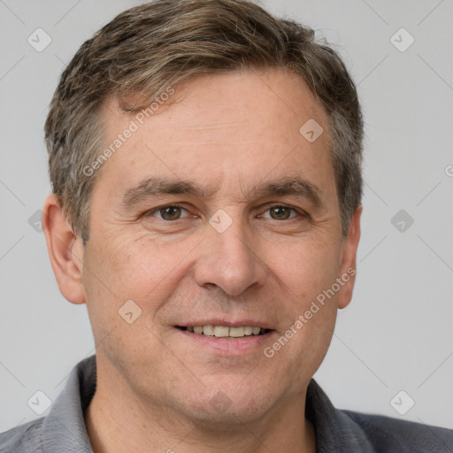 Joyful white adult male with short  brown hair and grey eyes