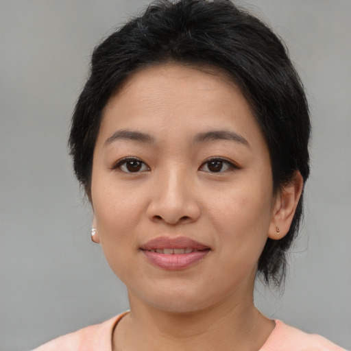 Joyful asian young-adult female with medium  brown hair and brown eyes