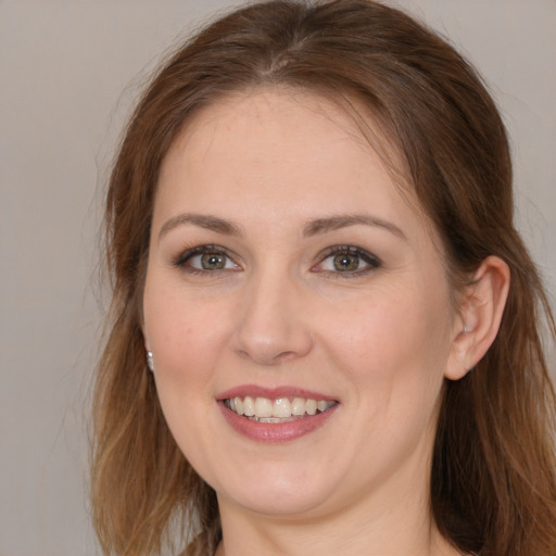 Joyful white young-adult female with long  brown hair and brown eyes