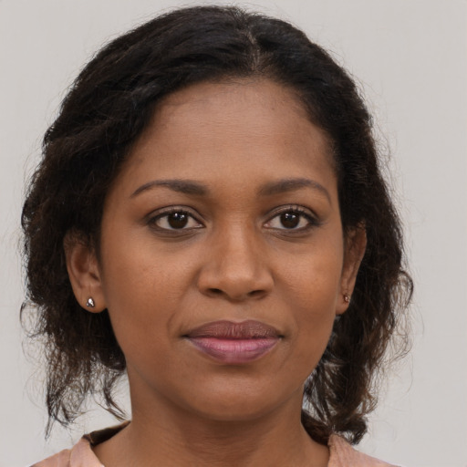 Joyful black young-adult female with medium  brown hair and brown eyes
