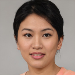 Joyful asian young-adult female with short  brown hair and brown eyes