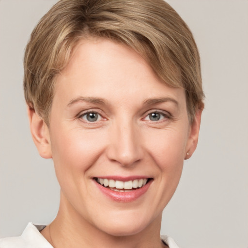 Joyful white young-adult female with short  brown hair and grey eyes