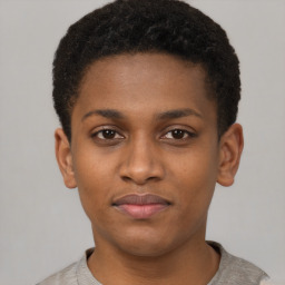 Joyful latino young-adult male with short  brown hair and brown eyes