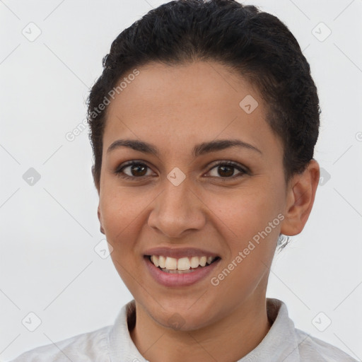 Joyful latino young-adult female with short  brown hair and brown eyes