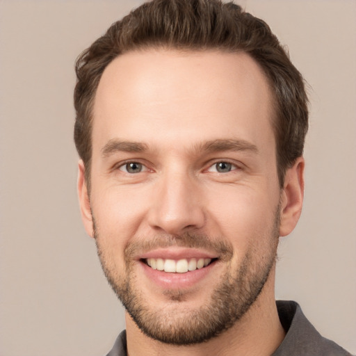 Joyful white young-adult male with short  brown hair and brown eyes