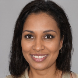 Joyful black young-adult female with medium  brown hair and brown eyes