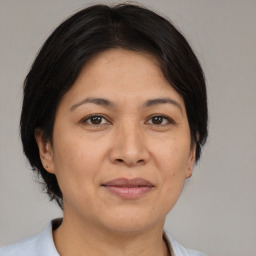 Joyful white adult female with medium  brown hair and brown eyes