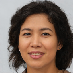 Joyful asian adult female with medium  brown hair and brown eyes