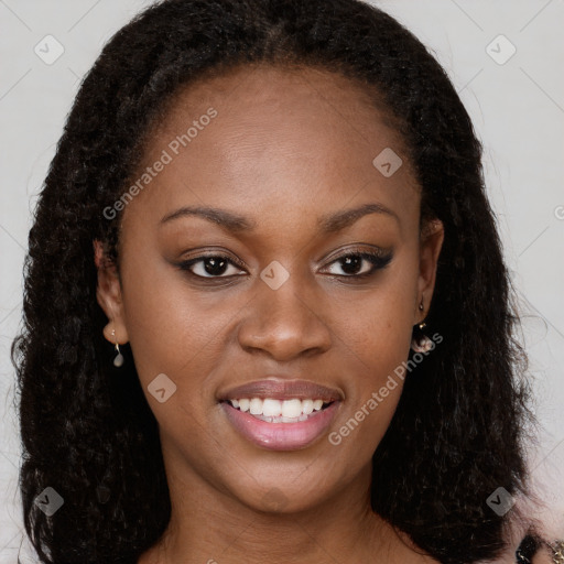 Joyful black young-adult female with long  brown hair and brown eyes