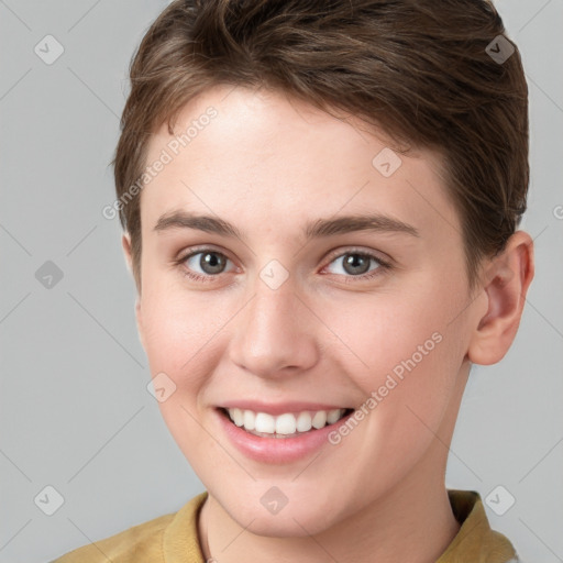 Joyful white young-adult female with short  brown hair and grey eyes