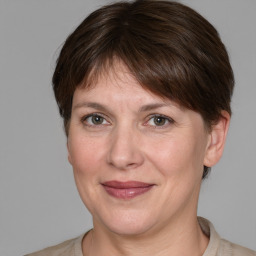 Joyful white adult female with medium  brown hair and grey eyes