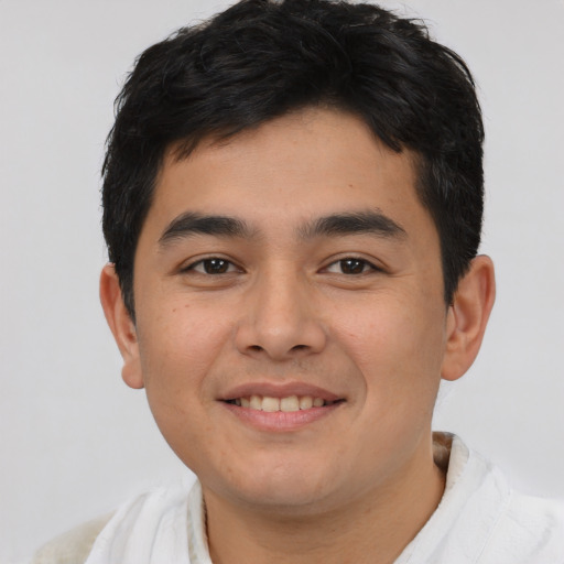Joyful latino young-adult male with short  brown hair and brown eyes