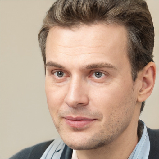 Joyful white adult male with short  brown hair and brown eyes