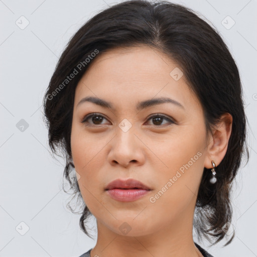 Joyful latino young-adult female with medium  brown hair and brown eyes