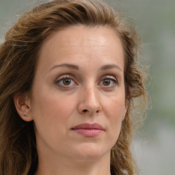 Joyful white adult female with long  brown hair and brown eyes