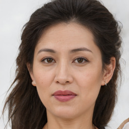 Joyful white adult female with long  brown hair and brown eyes